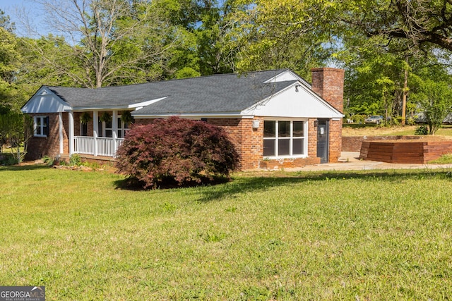 710 Avalon Rd, Thomaston, GA 30286 - single story home featuring a chimney, a front lawn, a porch, and brick siding