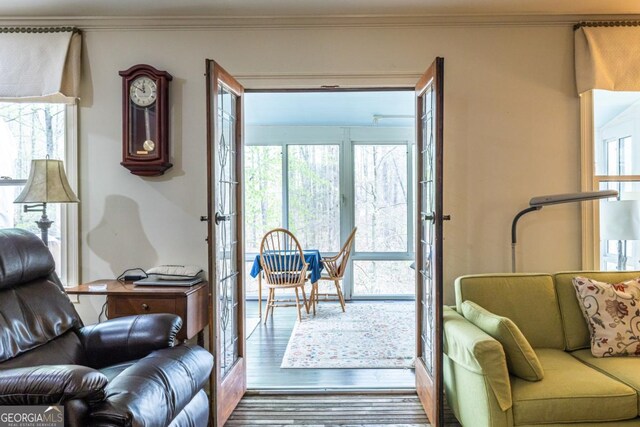 living room featuring ornamental molding and wood finished floors