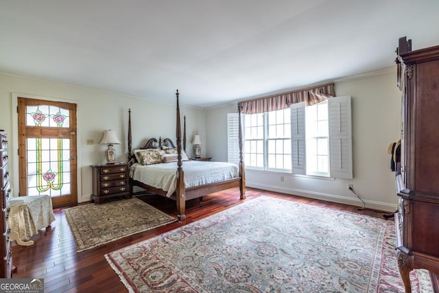 bedroom featuring baseboards, wood finished floors, ornamental molding, and multiple windows