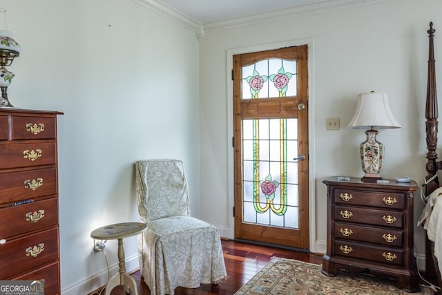 sitting room featuring wood finished floors, baseboards, and ornamental molding