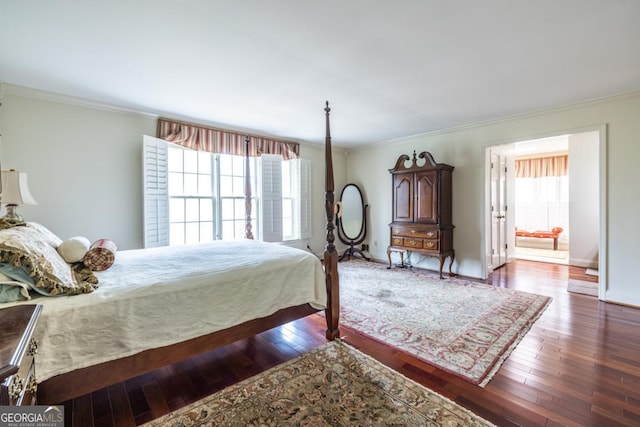 bedroom featuring baseboards, ornamental molding, and hardwood / wood-style floors