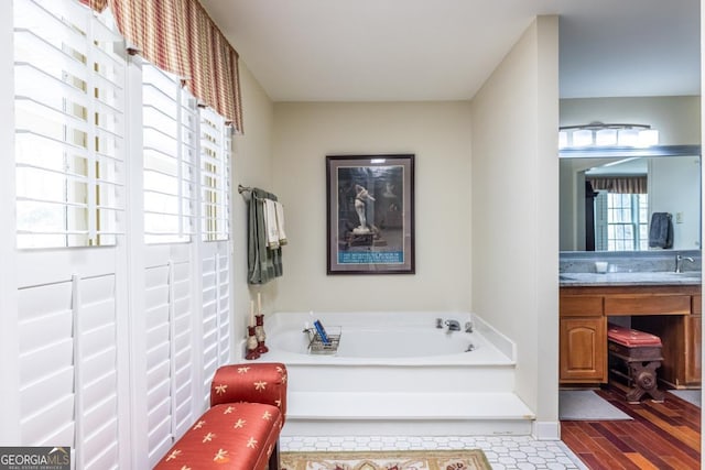 bathroom featuring a bath and vanity