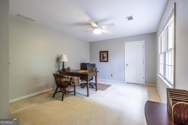 office with ceiling fan, light carpet, visible vents, and baseboards