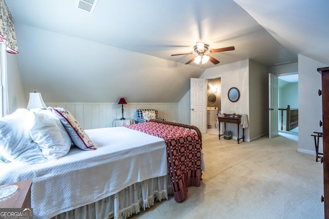 carpeted bedroom featuring baseboards, vaulted ceiling, visible vents, and a ceiling fan