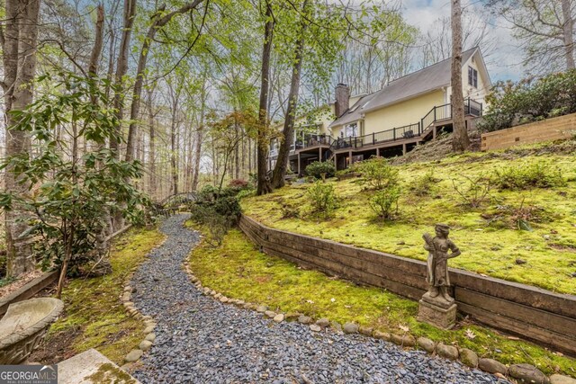 view of yard featuring stairway and a deck