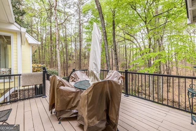 deck with outdoor dining area