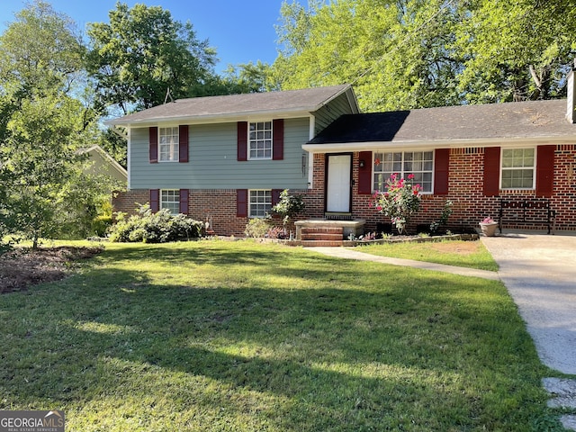 77 Crystal River Dr, Riverdale, GA 30274 - tri-level home featuring a front yard and brick siding