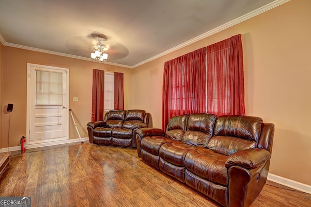 living area with baseboards, wood finished floors, ornamental molding, and ceiling fan