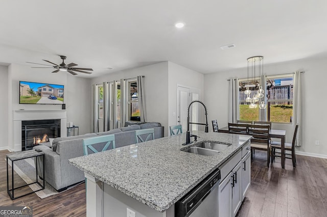 kitchen featuring dishwasher, visible vents, dark wood-style flooring, and a sink