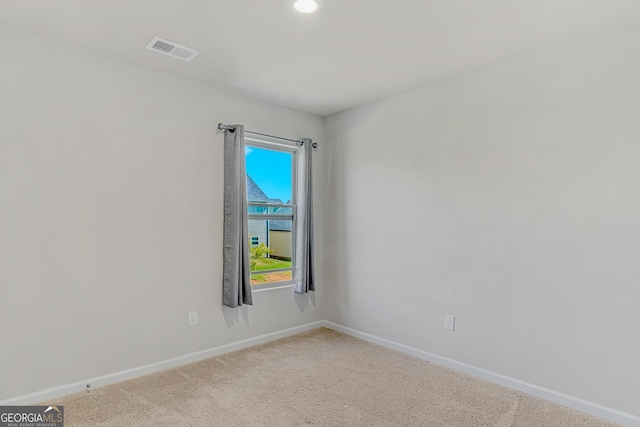 spare room featuring baseboards, carpet flooring, and visible vents