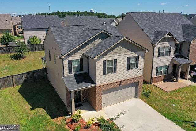 view of front of property with concrete driveway, brick siding, roof with shingles, and a garage