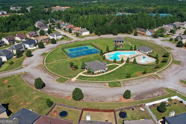 drone / aerial view with a residential view and a wooded view