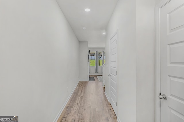 corridor with recessed lighting, light wood finished floors, and baseboards