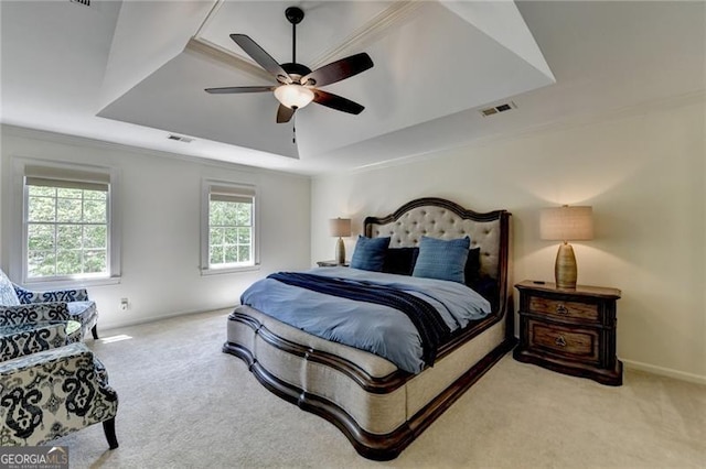 bedroom featuring visible vents, carpet flooring, and a raised ceiling