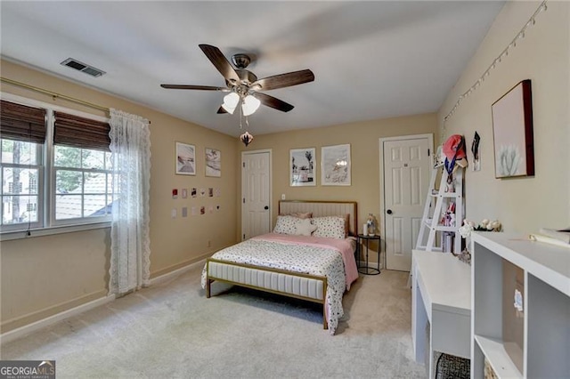 bedroom featuring ceiling fan, visible vents, baseboards, and light carpet