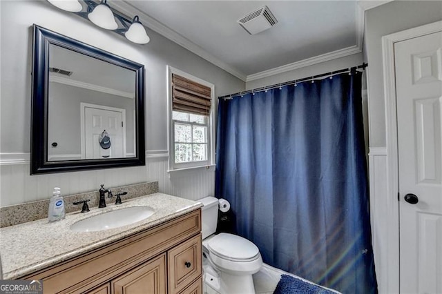 bathroom featuring visible vents, ornamental molding, and wainscoting