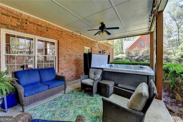 view of patio with a hot tub, a ceiling fan, and an outdoor hangout area