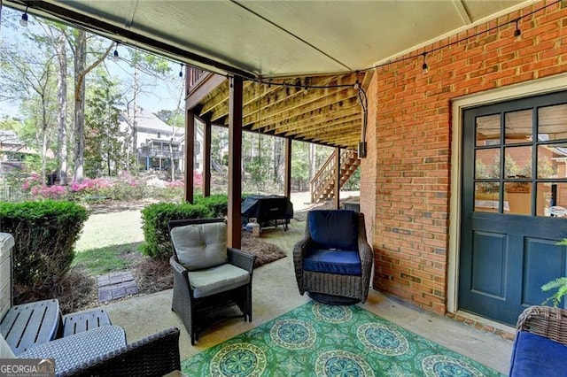 view of patio featuring area for grilling and stairs