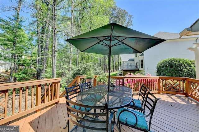 wooden deck featuring outdoor dining area