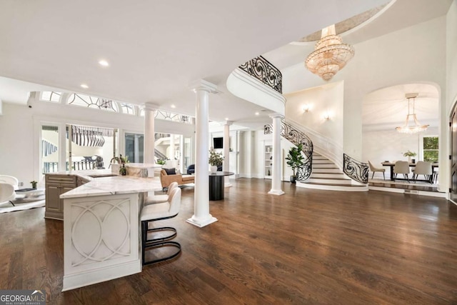 3511 Roxboro Rd NE, Atlanta, GA 30326 - interior space featuring recessed lighting, stairway, ornate columns, an inviting chandelier, and dark wood-style flooring