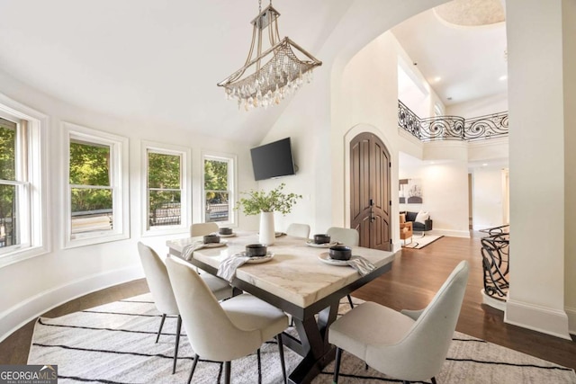 3511 Roxboro Rd NE, Atlanta, GA 30326 - dining area with arched walkways, wood finished floors, a towering ceiling, and baseboards