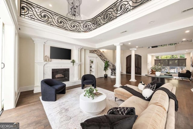 3511 Roxboro Rd NE, Atlanta, GA 30326 - living room with wood finished floors, decorative columns, visible vents, and a fireplace