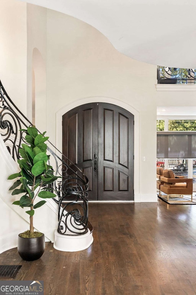 3511 Roxboro Rd NE, Atlanta, GA 30326 - entryway featuring wood finished floors, visible vents, arched walkways, baseboards, and stairs