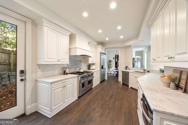 3511 Roxboro Rd NE, Atlanta, GA 30326 - kitchen with premium appliances, white cabinetry, a sink, custom exhaust hood, and dark wood-style flooring