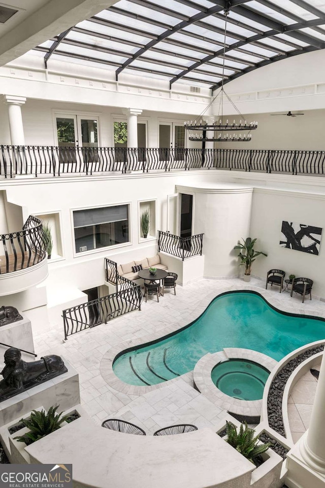 3511 Roxboro Rd NE, Atlanta, GA 30326 - view of pool featuring a patio area, a pool with connected hot tub, and an outdoor hangout area