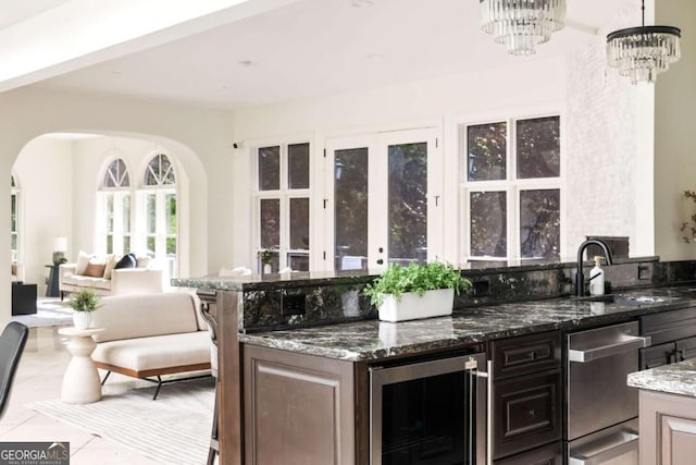 3511 Roxboro Rd NE, Atlanta, GA 30326 - interior space featuring wine cooler, dishwasher, a sink, arched walkways, and light tile patterned flooring