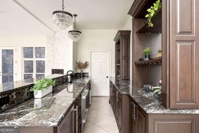 3511 Roxboro Rd NE, Atlanta, GA 30326 - kitchen with a sink, dark stone countertops, a chandelier, open shelves, and light tile patterned floors