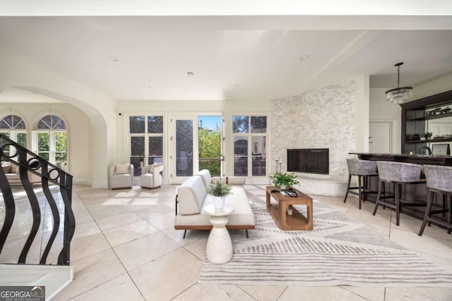 3511 Roxboro Rd NE, Atlanta, GA 30326 - tiled living room featuring arched walkways, indoor bar, and a fireplace