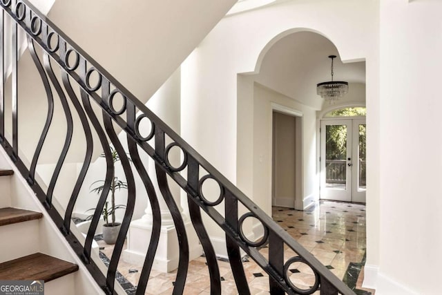 3511 Roxboro Rd NE, Atlanta, GA 30326 - staircase with baseboards, a notable chandelier, and french doors