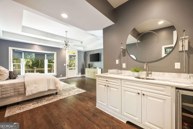 3511 Roxboro Rd NE, Atlanta, GA 30326 - bedroom with beverage cooler, a tray ceiling, a sink, dark wood-type flooring, and multiple windows