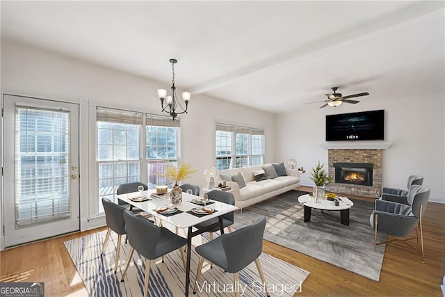 1268 Windsor Glen Dr, Douglasville, GA 30134 - dining room featuring wood finished floors, a brick fireplace, and ceiling fan with notable chandelier