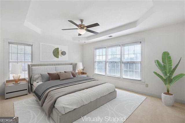 1268 Windsor Glen Dr, Douglasville, GA 30134 - carpeted bedroom featuring visible vents, baseboards, a ceiling fan, and a tray ceiling