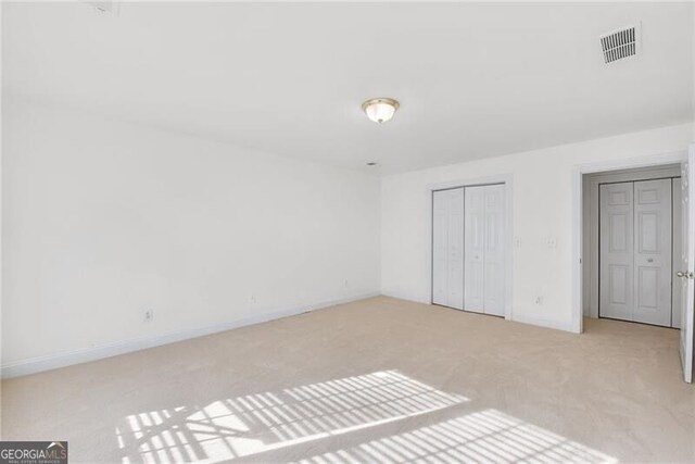 1268 Windsor Glen Dr, Douglasville, GA 30134 - unfurnished bedroom with baseboards, visible vents, a closet, and carpet flooring