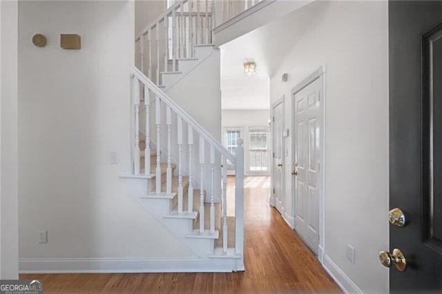 1268 Windsor Glen Dr, Douglasville, GA 30134 - foyer with wood finished floors, baseboards, a high ceiling, and stairway