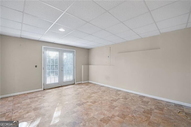 1268 Windsor Glen Dr, Douglasville, GA 30134 - spare room with a paneled ceiling, baseboards, and french doors