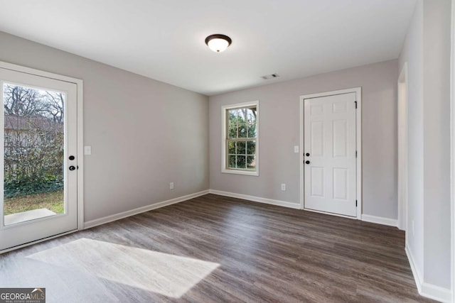 foyer featuring baseboards, visible vents, and dark wood-style flooring