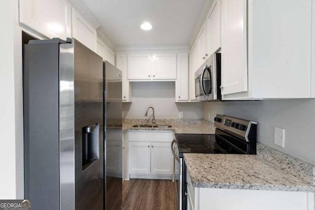 kitchen featuring white cabinets, stainless steel appliances, and a sink