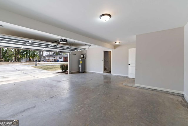 garage with a garage door opener, electric water heater, and baseboards