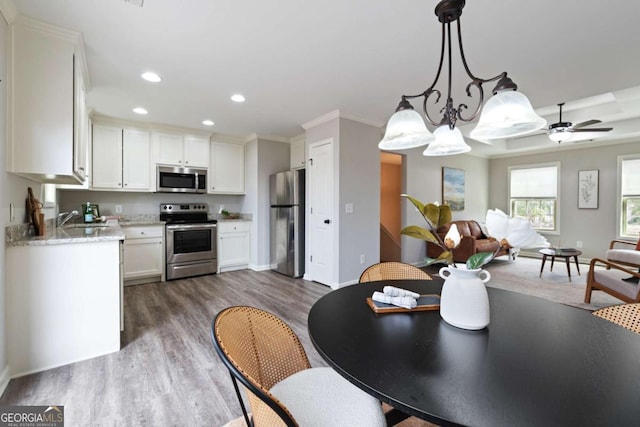 kitchen with open floor plan, stainless steel appliances, white cabinetry, dark wood-style floors, and recessed lighting