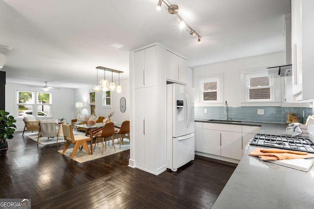 830 Belgrade Ave NE, Atlanta, GA 30306 - kitchen featuring white cabinets, a sink, backsplash, a ceiling fan, and white fridge with ice dispenser