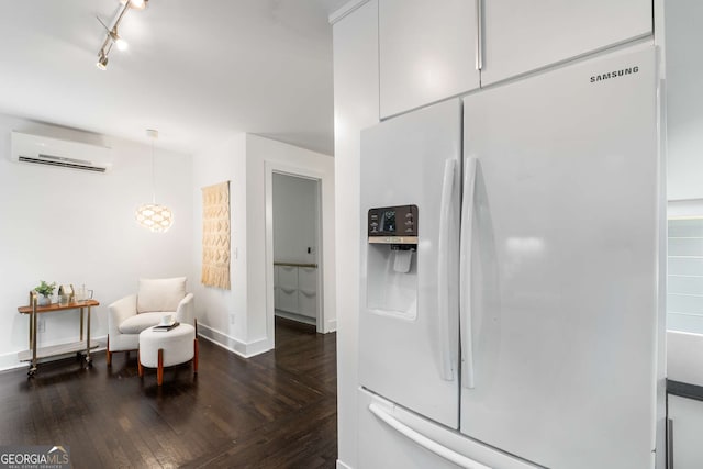 830 Belgrade Ave NE, Atlanta, GA 30306 - kitchen with an AC wall unit, baseboards, white cabinetry, white fridge with ice dispenser, and dark wood-type flooring