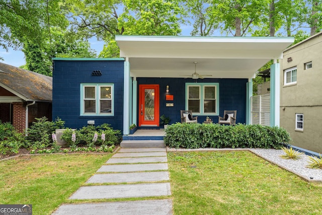 830 Belgrade Ave NE, Atlanta, GA 30306 - view of front facade featuring a front lawn, a porch, ceiling fan, and concrete block siding