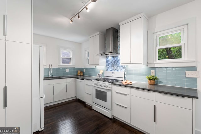 830 Belgrade Ave NE, Atlanta, GA 30306 - kitchen featuring white appliances, wall chimney exhaust hood, dark countertops, and tasteful backsplash