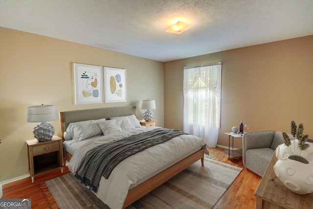 1005 Berkeley Woods Dr, Duluth, GA 30096 - bedroom featuring baseboards and wood finished floors