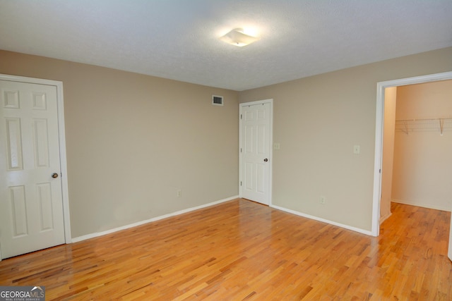 1005 Berkeley Woods Dr, Duluth, GA 30096 - unfurnished bedroom featuring light wood finished floors and baseboards