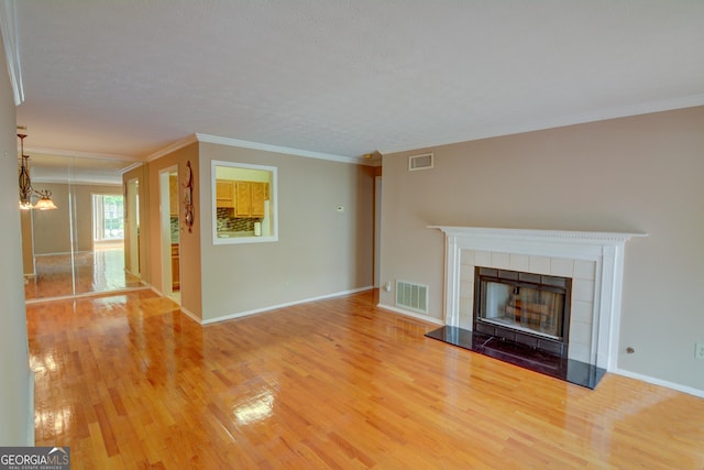 1005 Berkeley Woods Dr, Duluth, GA 30096 - unfurnished living room with wood finished floors, a fireplace, ornamental molding, and baseboards